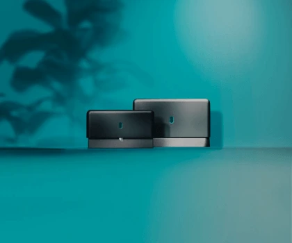 Two EE Smart hybrid broadband modems on a teal background