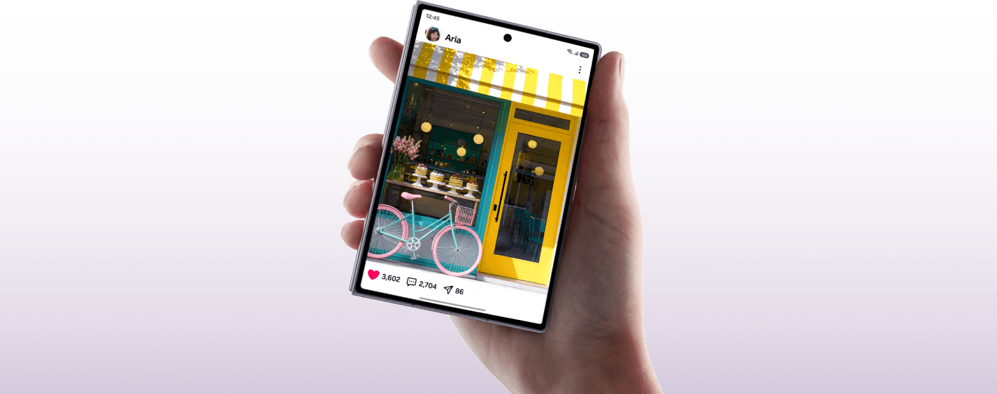 A hand holding the Fold8 device showing a social media post of a bakery