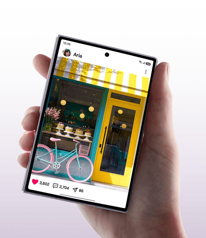 A hand holding the Fold8 device showing a social media post of a bakery
