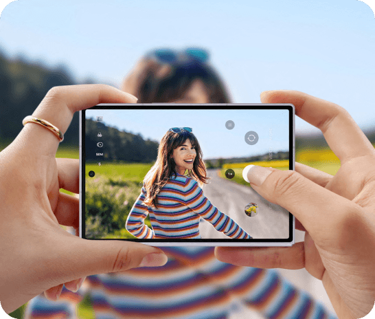 An image of someone holding the device taking a photo of a lady smiling