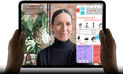 iPad Pro, front exterior, landscape orientation, space black colour, rounded corners, black display bezel, hands holding left and right sides, display showing a FaceTime conversation being live translated, and an educational app showing a presentation of Comparative Mythology with text, diagrams and handwritten notes