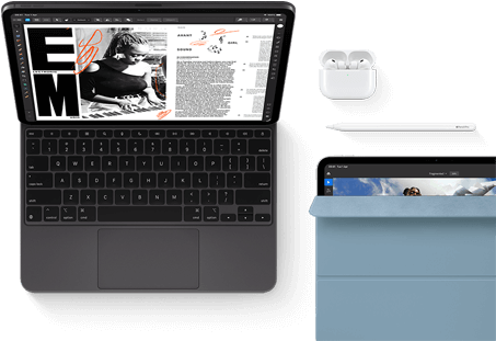 iPad Pro attached to Magic Keyboard, front exterior, space black colour, rounded corners, black display bezel, open, display showing article editing app with text and photograph of a woman playing music, Airpods 4 in open case, blue Smart Folio cover on iPad Pro with Apple Pencil Pro resting atop device, cover slightly open revealing display