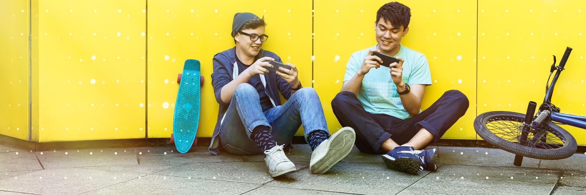 Two students playing a game on their smartphones