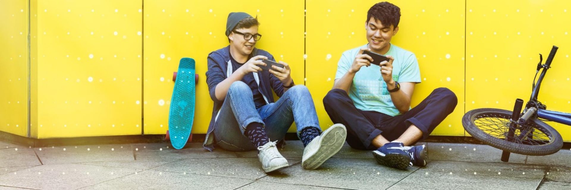 Two students playing a game on their smartphones