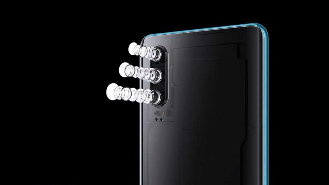 The back of a Huawei P30 shown on a black background with the flash components deconstructed