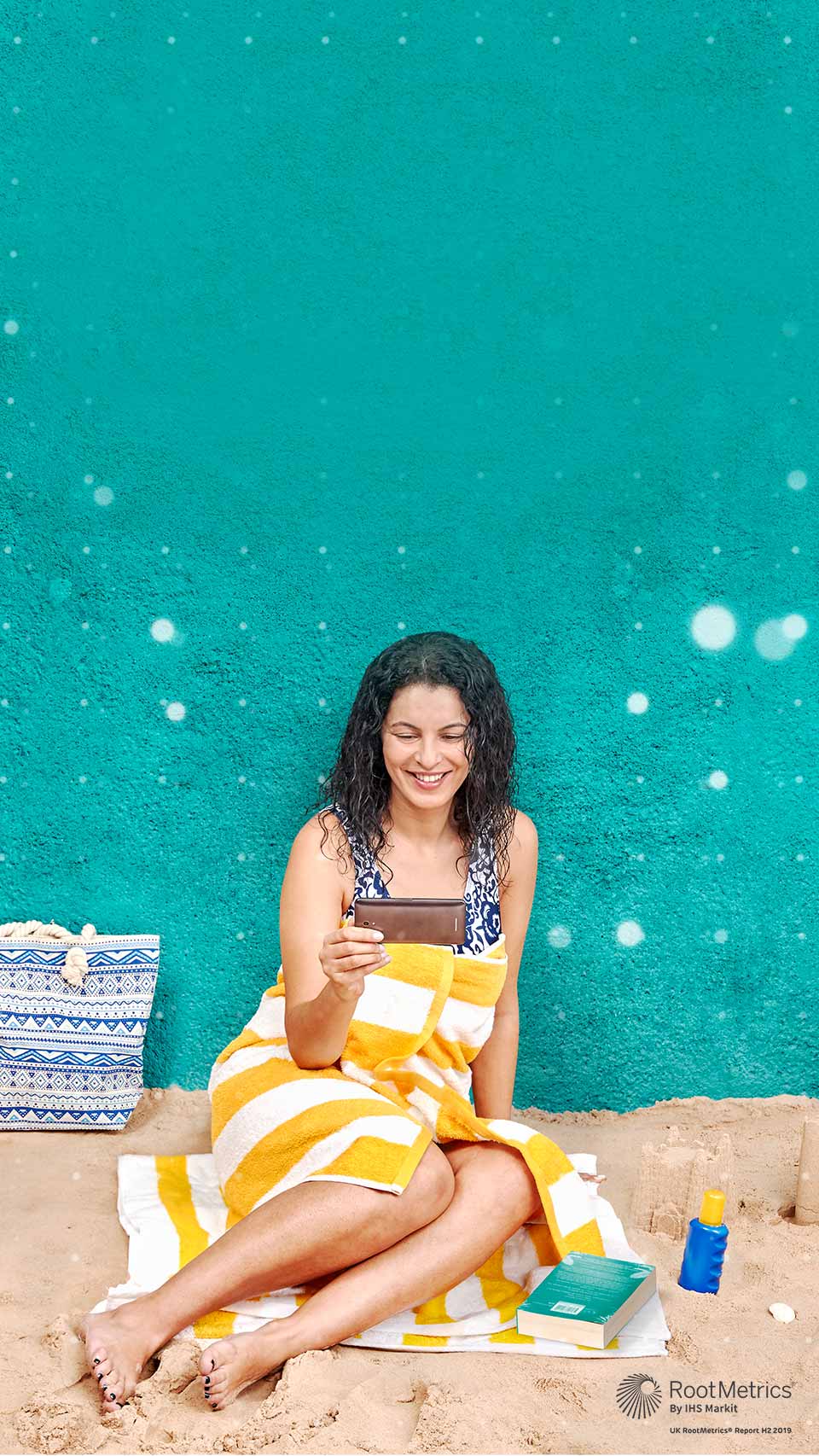 Woman on the beach holding a mobile device