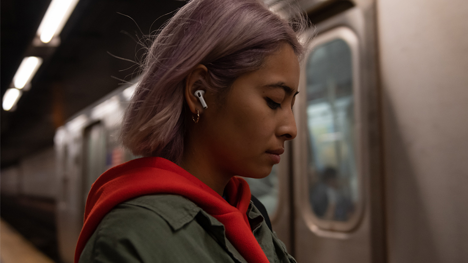  An AirPod Pro user waiting on a platform for a train 