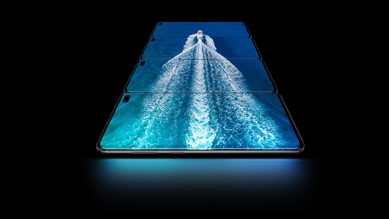 Four Galaxy S10 smartphones stacked together showing an image of a boat in the ocean