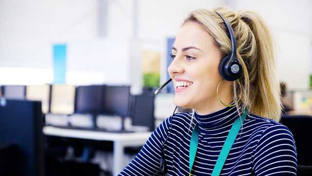 EE call centre worker wearing a headset and speaking to a customer