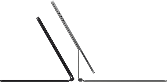 Two Magic Keyboards with iPad Pro attached shown back to back in Space Black and Silver finishes