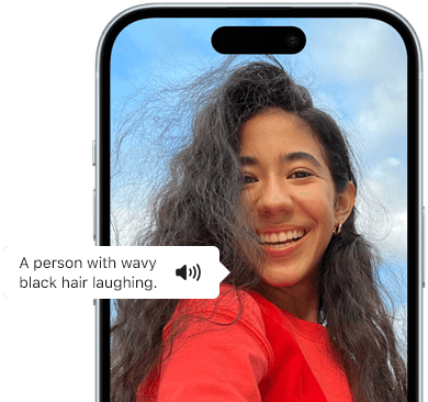 iPhone 15 showing Voiceover feature announcing the picture information: a person with wavy black hair laughing