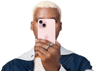 Person holding iPhone 15 in front of his face to conceal indentity