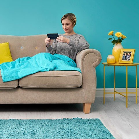 Woman on sofa reading her phone