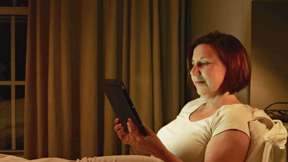 Woman in bed with tablet