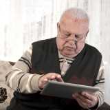 Old man using tablet