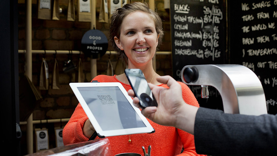 Person paying for their bill using a smartphone