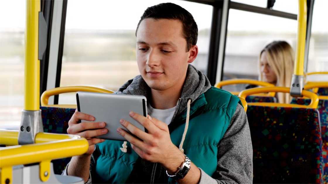 Man with a tablet on the bus