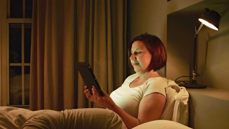 Woman on tablet in bed