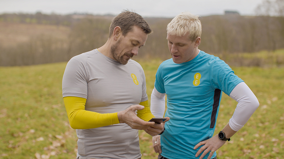 Jamie and Ollie training together, looking at their Galaxy smartphone