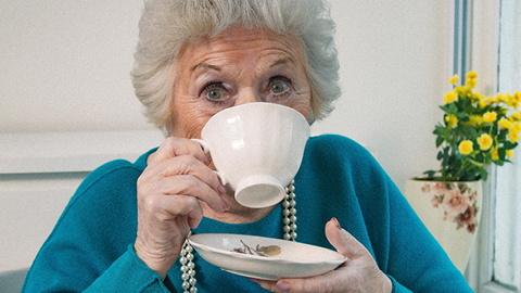 Image of a woman drinking from a cup