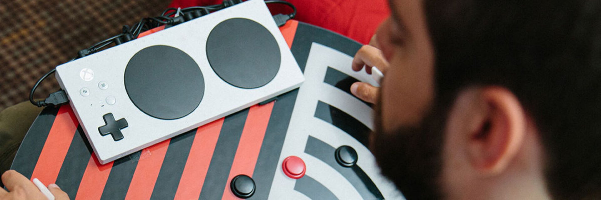 A disabled person using Xbox Adaptive Controller for video games