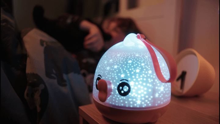 A children's night light on in a child's bedroom