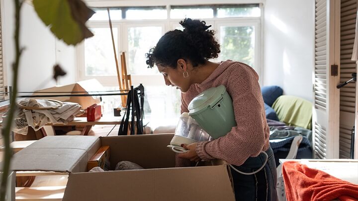 A woman unpacking boxes in a new home