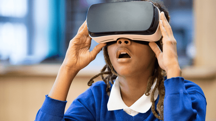 A schoolboy wearing a VR headset